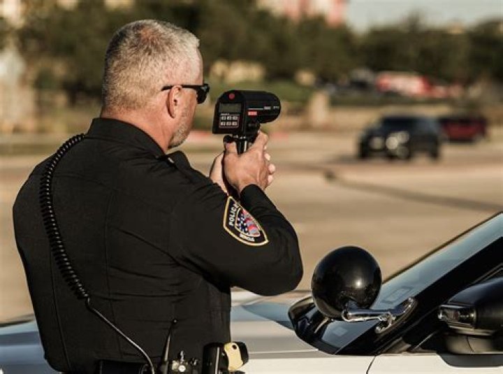 Law enforcer with a radar gun informally