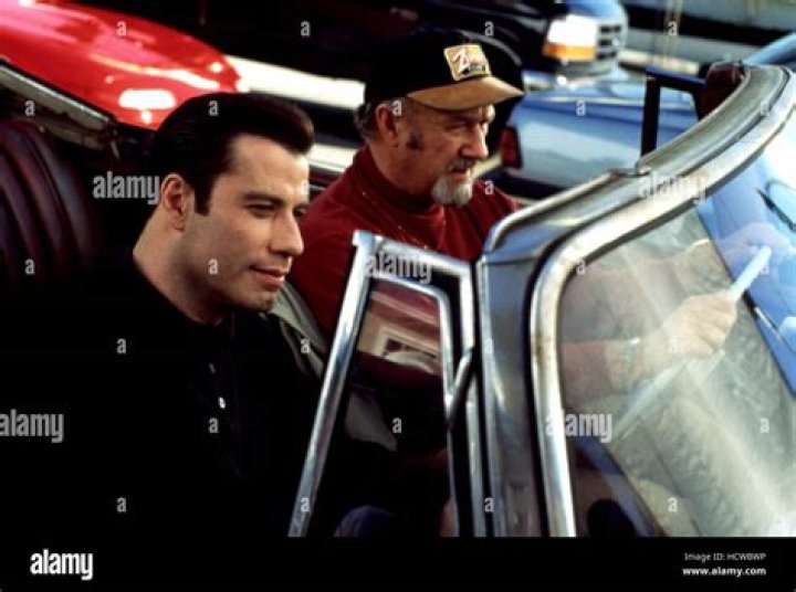 Rene Russo's costar in the 1995 gangster comedy Get Shorty: 2 wds.