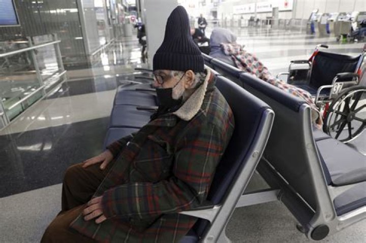 Settles into a chair