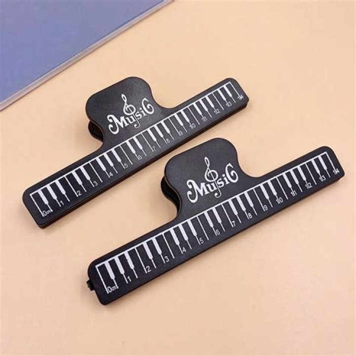 Shiny round music holders: Abbr.