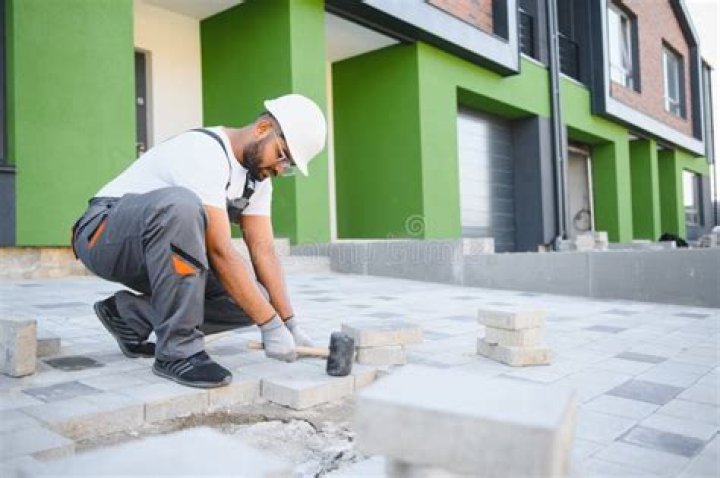 Worker with stones and bricks